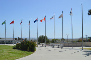 Different Country flags wave high outside the Olympic Training Center Visitor Center near the archery range