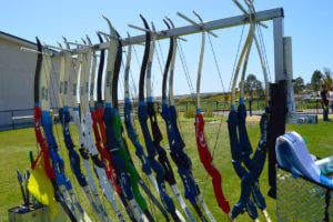 Archery bow rack full of archery equipment provided by Roadrunner Archery lesson in San Diego